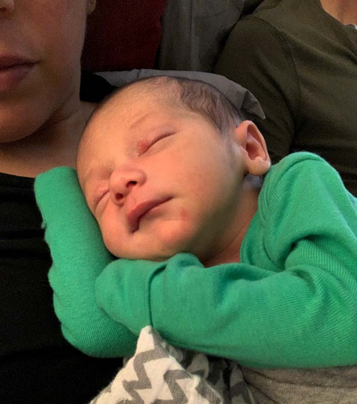 This picture pretty well sums up our second week of parenting: baby mostly slept on mom while dad (back right) stood on standby to take care of other things that needed to be done.