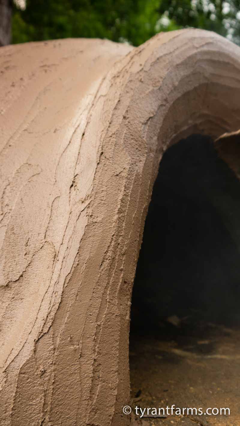 A final look at the wet earthen coating layer around the door of the oven.