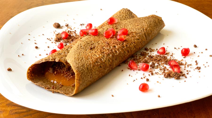 Our acorn flour crepes - especially good stuffed with American persimmon pulp and topped with pomegranate seeds from our back yard.