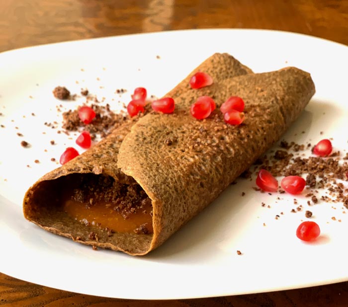 This sweet version of our acorn flour crepes is filled with raw, strained American persimmon pulp and pecan crumble (also used as a garnish). We topped it with pomegranate seeds from our heirloom pom tree. 