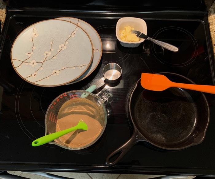 Put everything you need right around your crepe pan: batter, spatula, ladle, dishes to cover crepes, and butter.