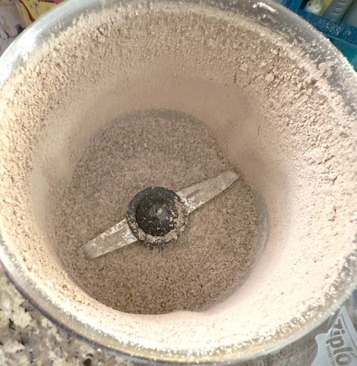 Grinding acorn flour even finer with a spice grinder.