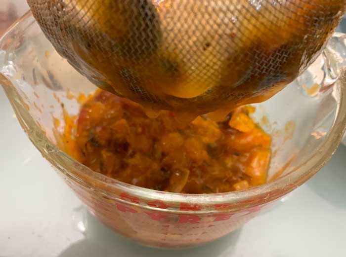 Getting as much pulp off of the American persimmon seeds as possible via metal strainer.