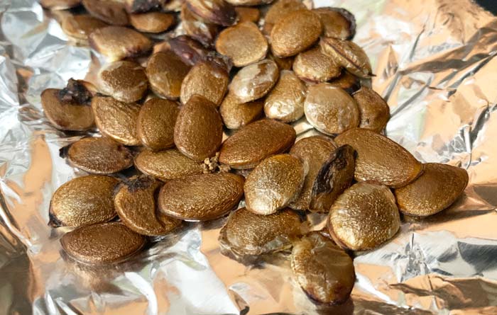 Roasted persimmon seeds coming out of the oven.