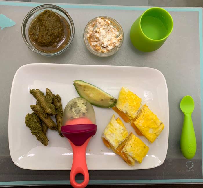 Starting top left: a) kale, apple, pear puree, b) cottage cheese with cashew butter, c) pesto on penne pasta, d) native passion fruit inside chew (so baby doesn't choke on seeds), e) avocado slice, d) duck egg omelette. 