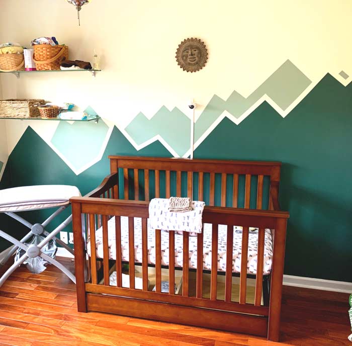 Baby nursery painted with mountains.