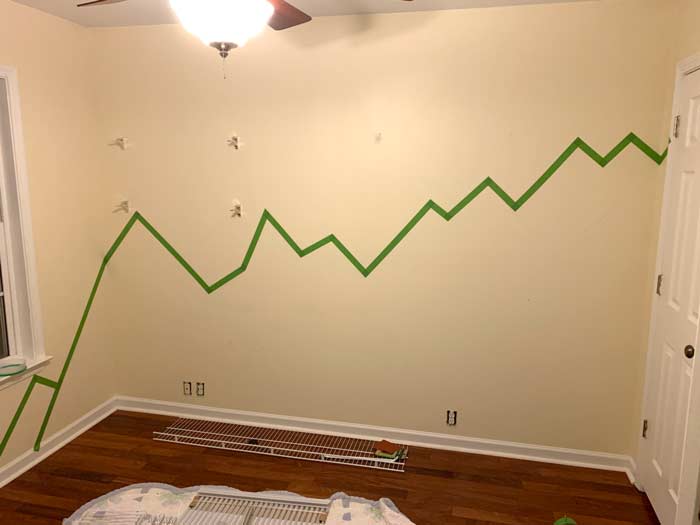 Baby nursery paint prep: First layer of paint tape outlining the foreground mountains.