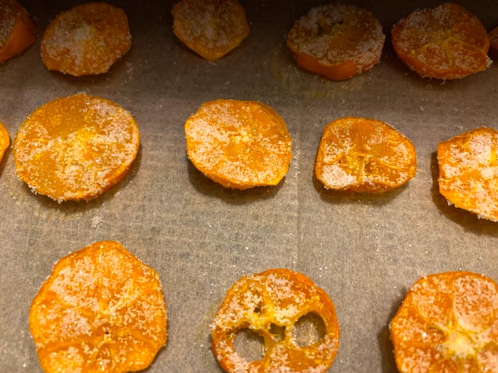 Sugar-coated calamondin slices returning to the dehydrator for the final leg of their journey.