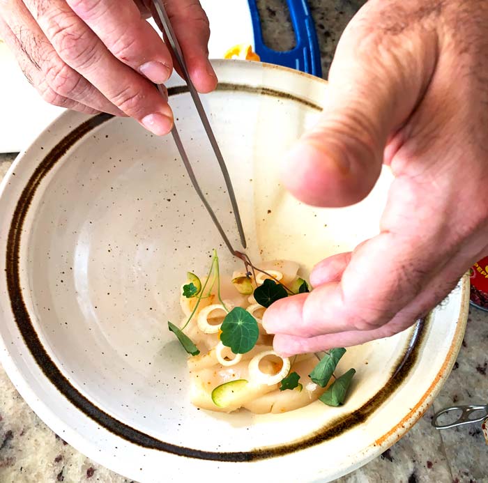 Chef David plating his calamondin-scallop aguachile. Notice how he places the slices of scallop elevated on the side of the bowl. That way, the garnishes stay on and when he pours the brine in, the scallops don't continue to "cook" in the high acid brine. Ideally, each spoonful you eat can have a little bit of every ingredient on it since the complexity and interplay of flavors is rather marvelous.
