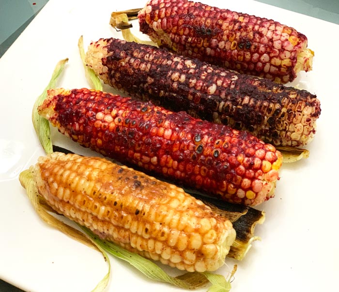 Cast iron corn on the cob basted with lacto-fermented fruit rubs. From left to right: 1) peach, purple basil, and honey, 2) blackberry, 3) blueberry, 4) cherry. 