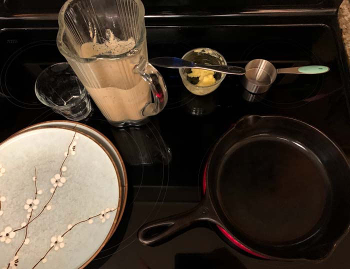 Batter, plates to cover finished crepes, butter & knife, 1/3 cup measuring cup used to ladle batter. Only thing not shown is silicone spatula used to loosen sides of crepe before sliding it out of pan. 