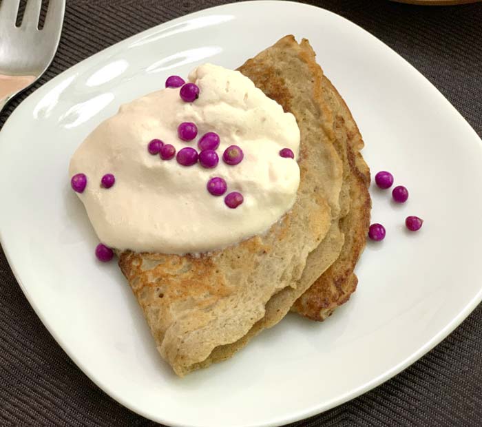 A generous dollop of beautyberry whipped cream and a beautyberry garnish atop a chestnut flour crepe. Time to eat!