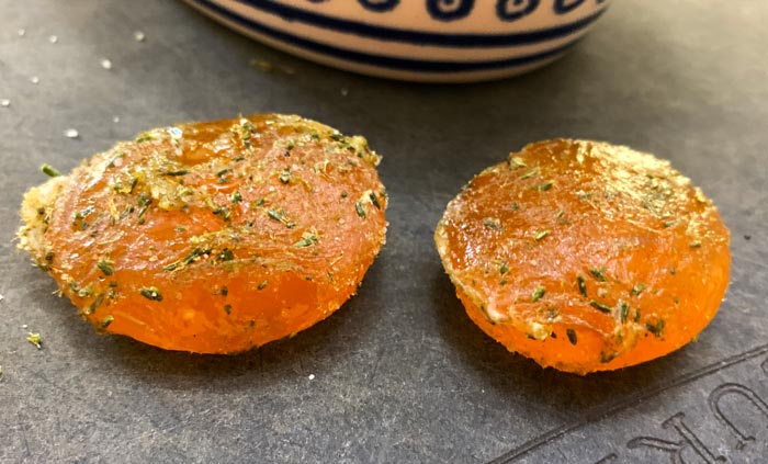 Cured undried egg yolks freshly removed from conifer needle salt. They're still a bit tacky and rubbery at this point.