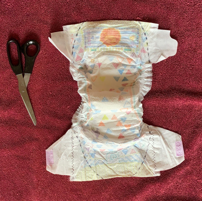 2. Prepare for cutting! Dotted lines are placed on the diaper insert to show you where the first cuts to trim and remove the diaper flaps will be made.