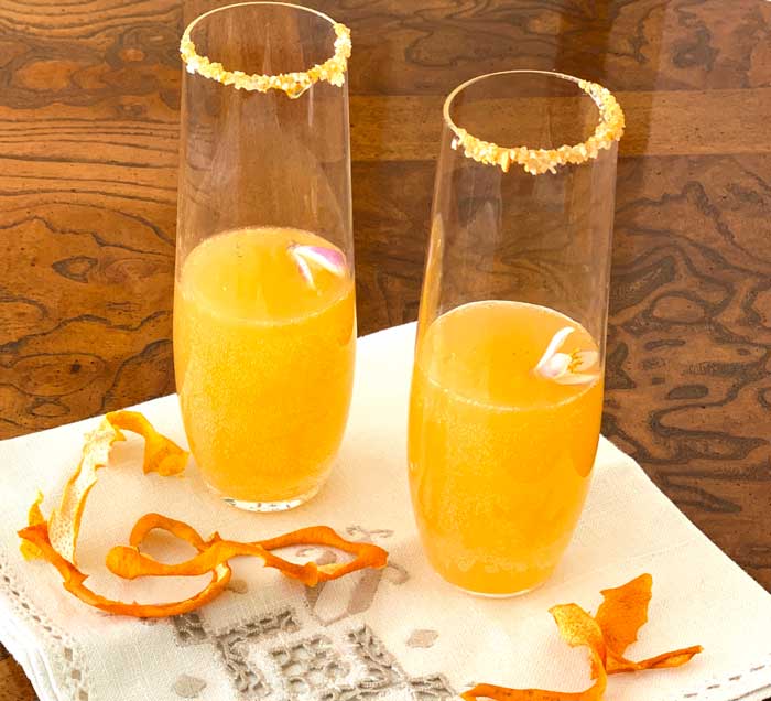 Fermented lemonade is great by itself or as a base for adult beverages. This a straight mocktail version with no alcohol, garnished with citrus blossoms. Dehydrated lemon skins (bottom) can be used in everything from sauerkraut to baked dishes. We also ground up some of the dried skins with salt and sugar to rim the glass (dip the glass in honey first to get it to stick).