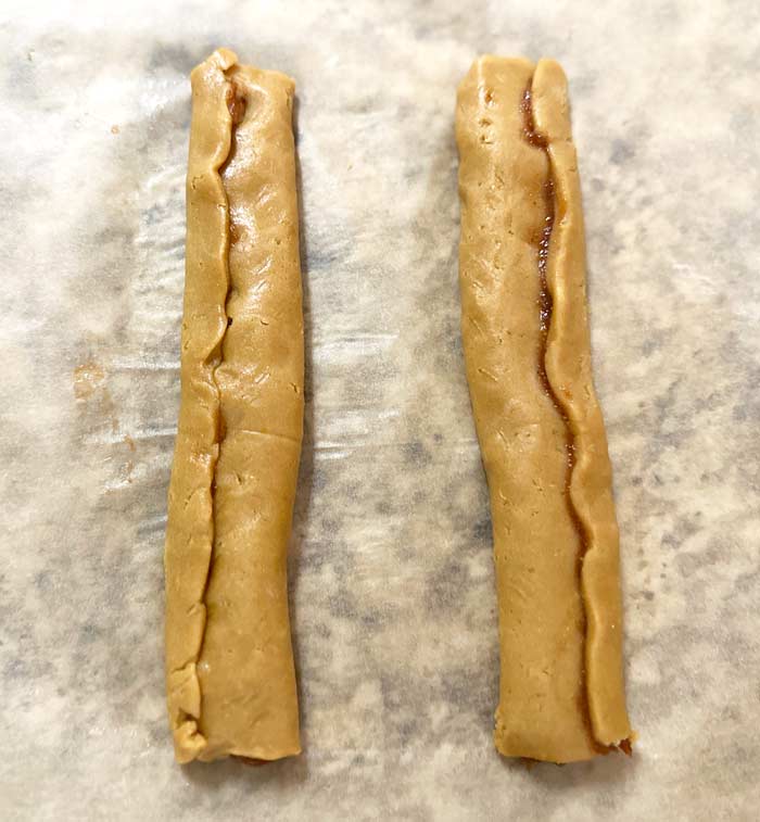 Wrapped up Fig Newton strips ready to be transferred to the baking sheet.