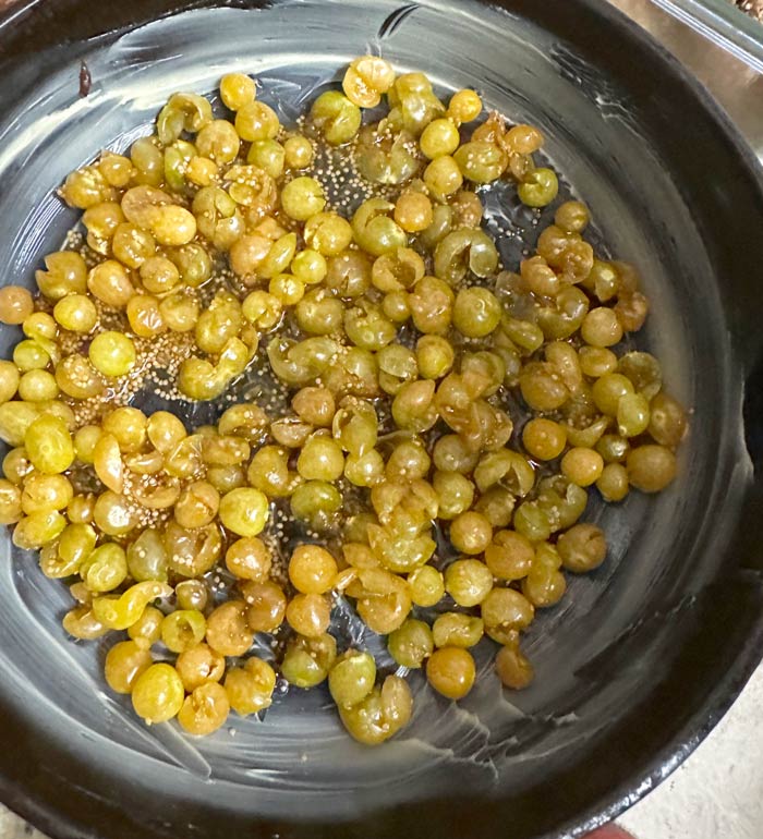 Spread smashed ground cherries (with a bit of sugar and vanilla added) evenly on the surface of the buttered pan. This shows a 1 cup ground cherry crumble but you can go up to 2 cups, as mentioned earlier.