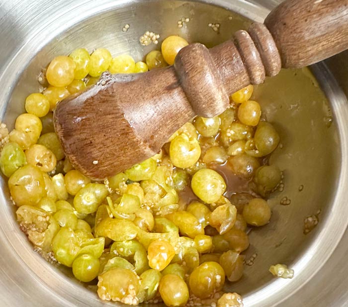 We smash the ground cherries first so there's not exploding ground cherries in the oven.