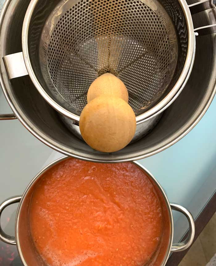 Straining cooked guava fruit through a chinois strainer is an easy way to remove the small, rock-hard seeds. 