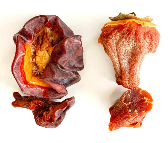 The exact same variety and size of persimmon, preserved two different ways. Left: Standard dehydrated persimmon made from a squishy ripe persimmon. Right: Hoshigaki persimmon made from a firm ripe persimmon.