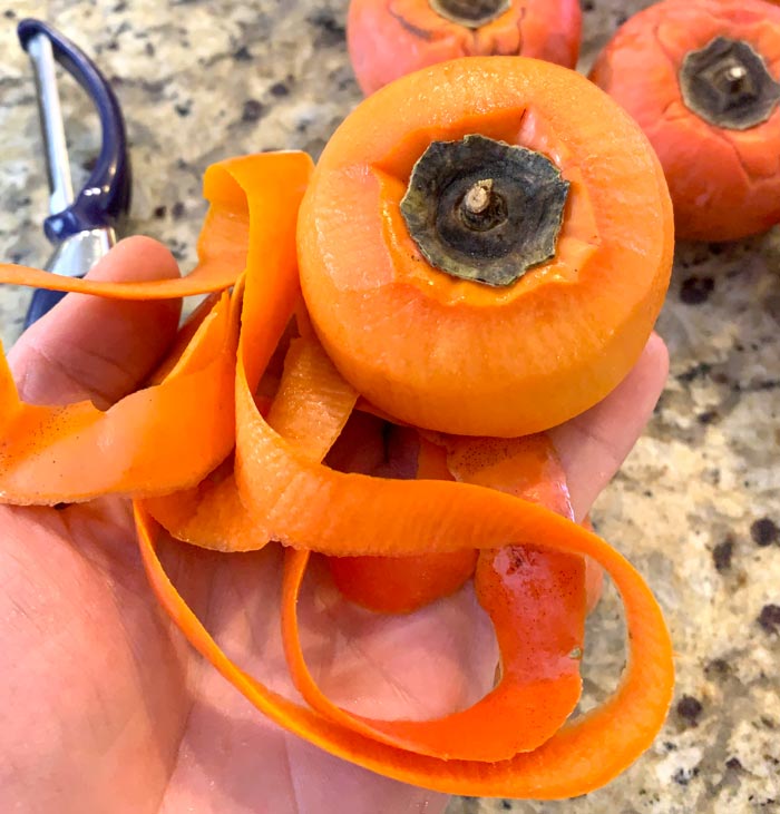 Peeling Asian persimmons.