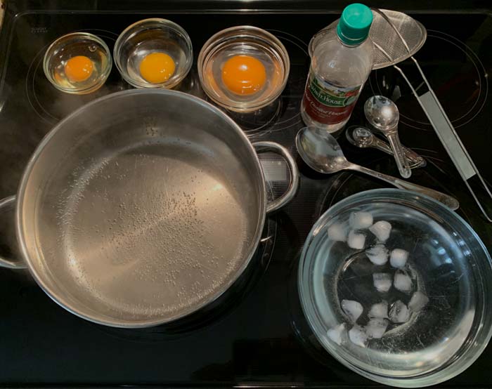 Everything ready to go to poach eggs! Here you can also see the fish eye bubbles in the water at the perfect stage of simmering to add the eggs. Since these eggs aren't being eaten immediately, we also have an ice bath ready. 