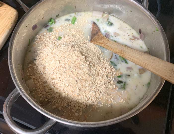 Powdered lion's mane mushrooms being added to the soup. 