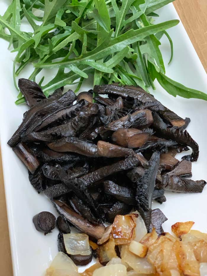 A few of the toppings we use to make the perfect burger: Sylvetta arugula, corrugated milk cap mushrooms, and caramelized onions.