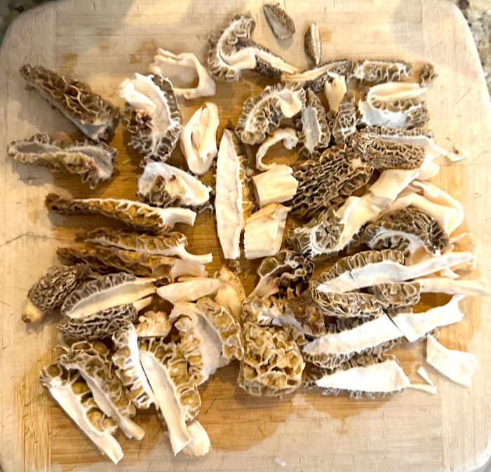 Morel processing tips: 1. You don't want any sand or grit in your dish. If necessary, flash rinse your morels in cold water prior to cutting. 2. Also, always cut a morel mushroom in half before cooking since there can sometimes be insects or other critters living in the central cavity. Better to find it in the prep phase than the eating phase of a meal. 3. Cut larger morels into ~1