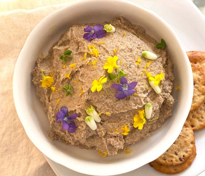 Morel mushroom pâté garnished with viola flowers, wood sorrel (flowers and greens), Solomon's seal flowers, and lemon zest. 