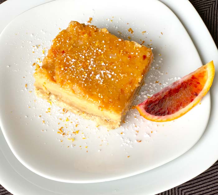 'Moro' blood orange bars with sage brown butter shortbread crust. Garnish: a dash or blood orange zest and powdered sugar. Moro blood orange dessert recipe.