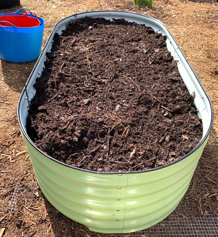 Homemade compost filling up the new raised garden beds.