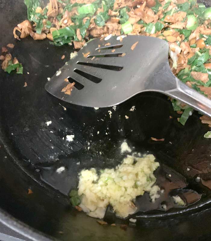 As your chanterelles and milkweed are finishing up, add diced garlic and a bit of olive oil to a corner of the pan to cook the garlic, which only takes ~2 minutes to cook. Then mix garlic into chanterelle-milkweed mixture.