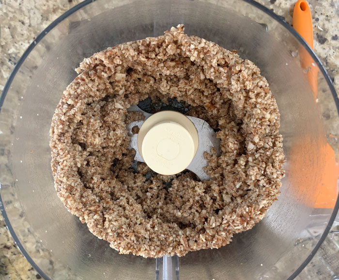 Making the toasted nut crust portion of this cheesecake recipe. Here you can also see the consistency of the finished ingredients before we put them into the springform pan to make the crust.