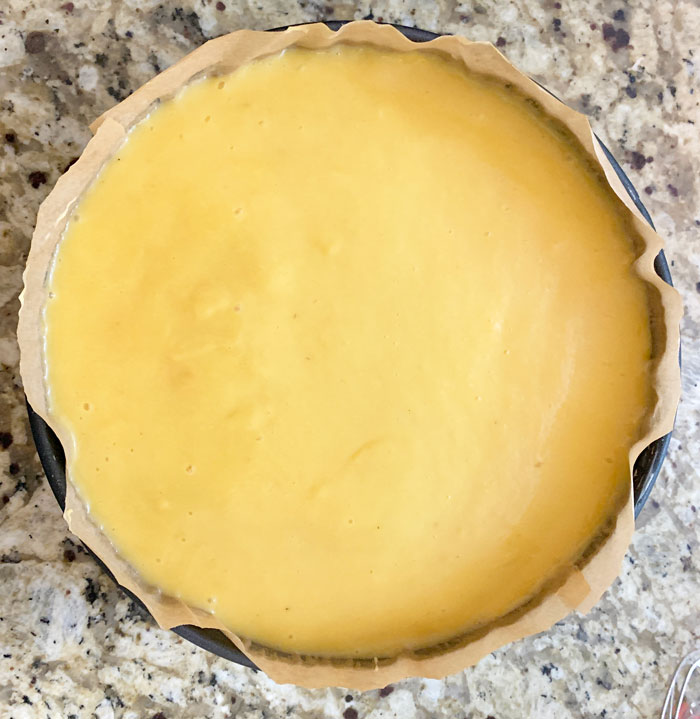 Pawpaw gelatin evened out on surface (note the yellow color). This cheesecake is ready to go in the fridge to set!