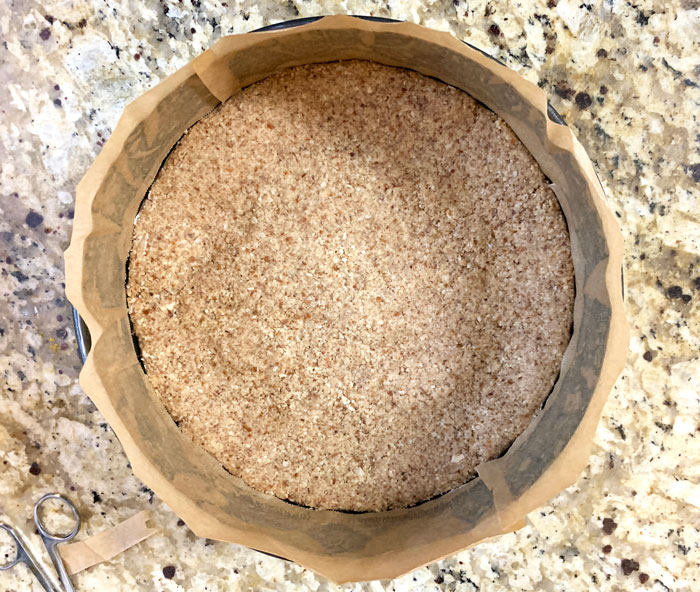 Note the parchment paper strips stuck to the buttered sides of the springform pan. This is a VERY important step if you want to have an attractive cheesecake at the end!