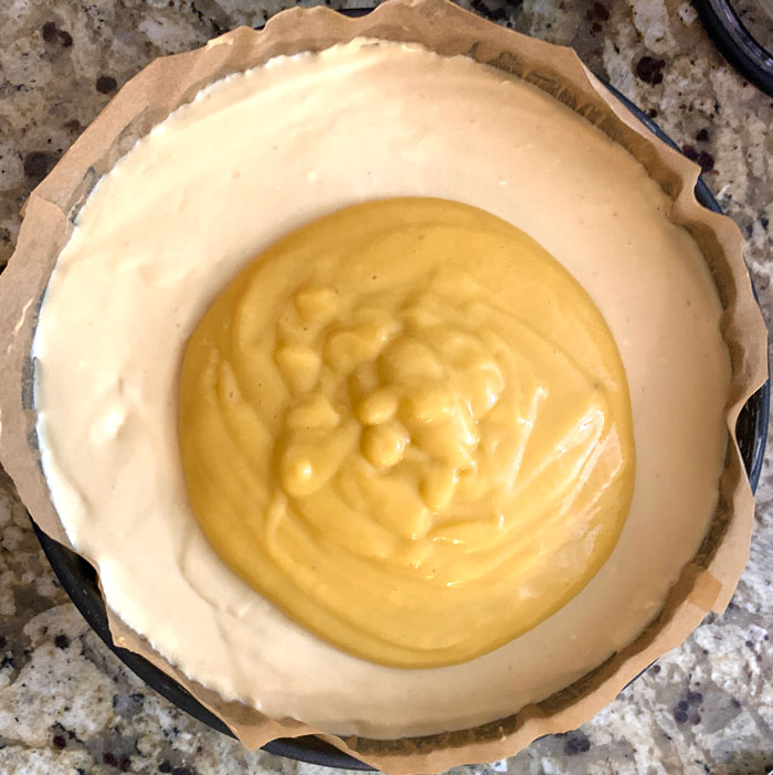 Finished pawpaw gelatin just poured atop the chilled cheesecake and ready to be evened and smoothed out over the surface. 