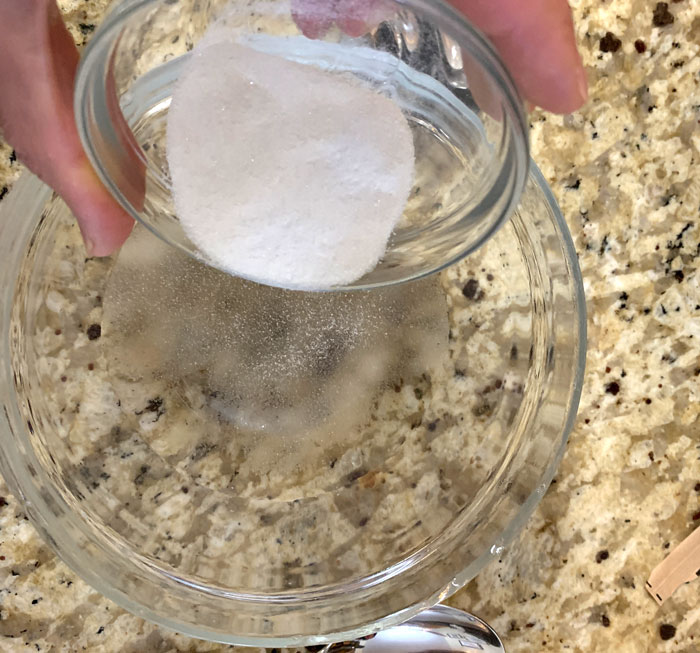 Measure out your gelatin and put it into a small bowl before sprinkling it on the water. Again, don't dump all the gelatin into a pile on the surface or it will form a giant glob. Once sprinkled, stir with a spoon and let it set for 5 minutes.