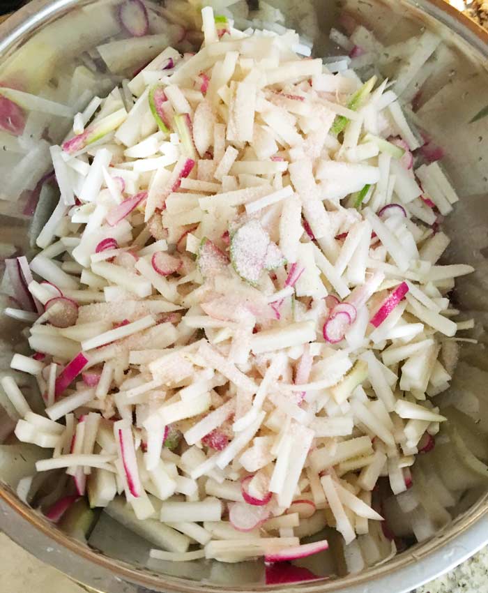 Salted matchstick-chopped daikon radishes, plus round of colored radishes (including watermelon radishes).