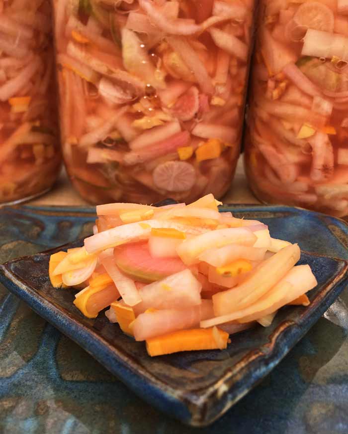See the tiny orange pieces of pickled turmeric in this ferment? Pickled daikon radishes with ginger and orange turmeric.