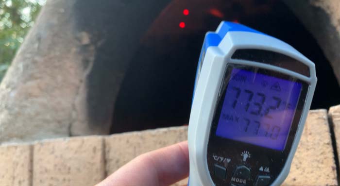 A laser thermometer helps in wood-fired cooking