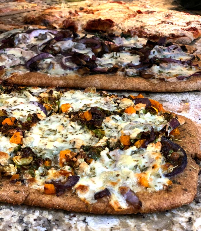 Homemade wood-fired pizzas fresh out of the cob oven.