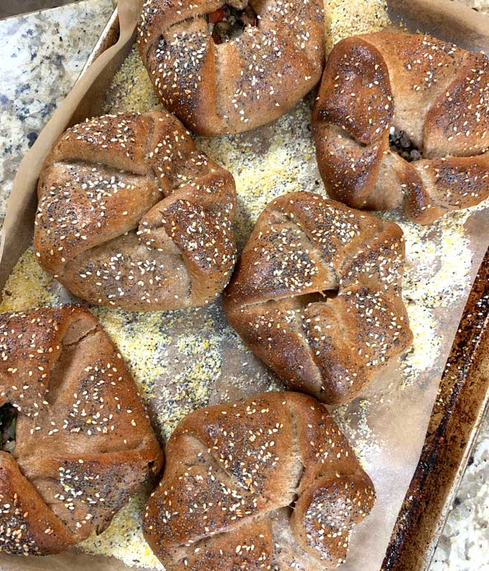 Homemade wood-fired poğaças, fresh out of our cob oven!