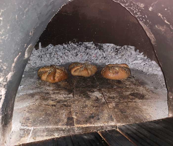 A single row made it much easier to get to and turn each poğaça. Cob oven baking.