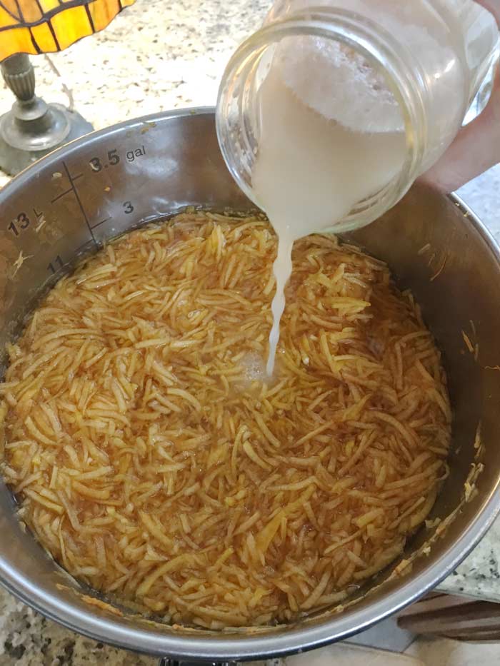 24 hours after the Campden tablet has been added and had a chance to wear off, you'll be adding your champagne yeast. Also notice how much color has already leached out of the grated pumpkin into the water.