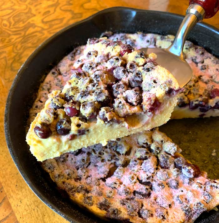 Crustless serviceberry custard pie (sweet flaugnarde) being served.
