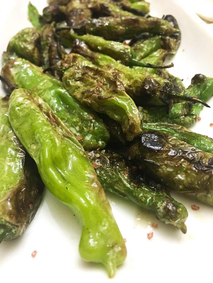 Blistered green Shishito peppers are a perfect summer side. 