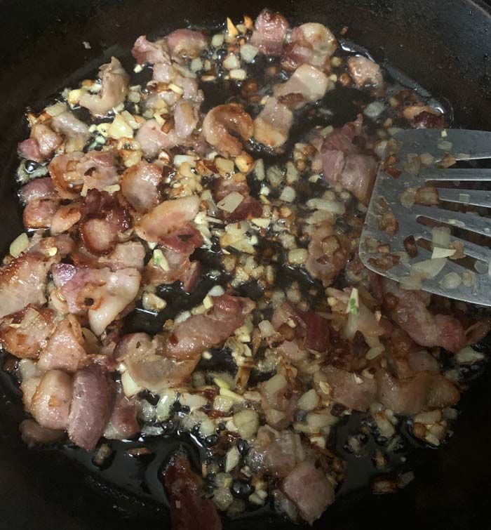 Bacon and onions cooked; garlic just added.