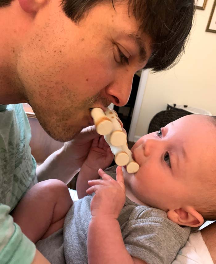 Sebastian and dad enjoying a shared nibbling of Sophie the Giraffe's legs.