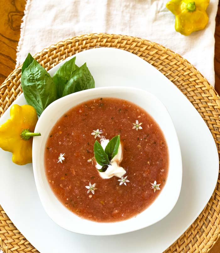 Perfecto! Watermelon gazpacho topped with a dollop of whole sour cream, garlic chive flowers, and African blue basil.